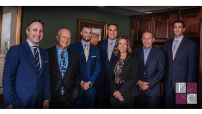 Gregory E. Fellerman with team