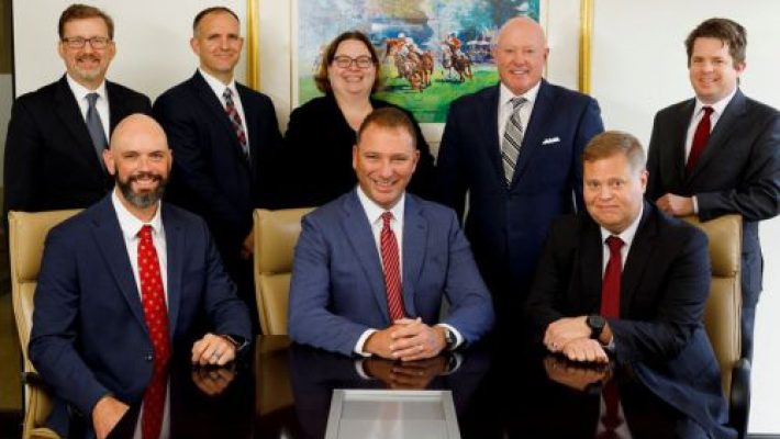 James E. Arnold with team