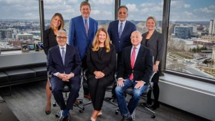 Larry E. Coben with team