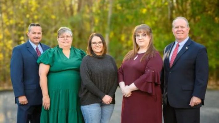 Leslee F. Hughes with team