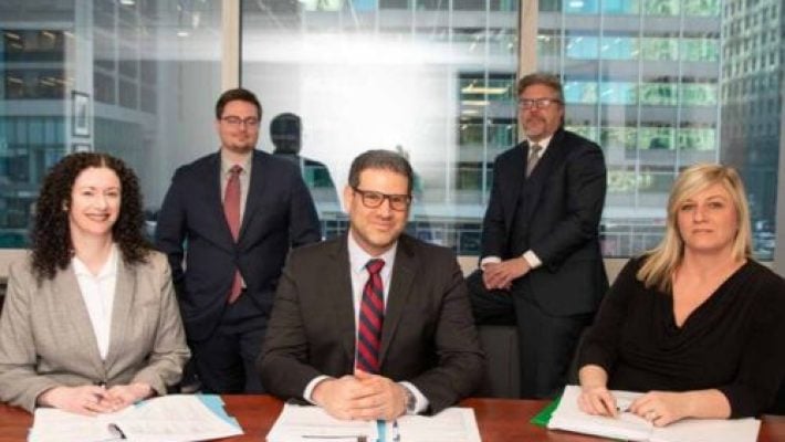 Raymond M. Kempinski with team