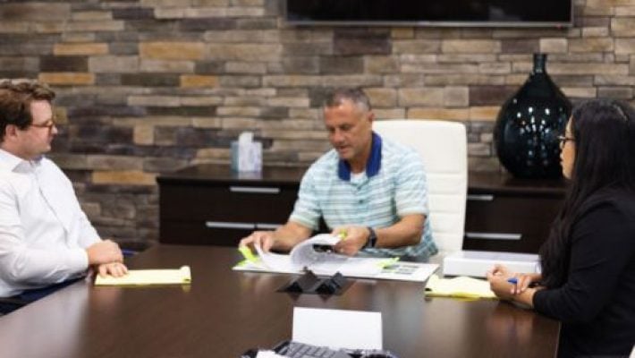 Shawn B. Daniels with team
